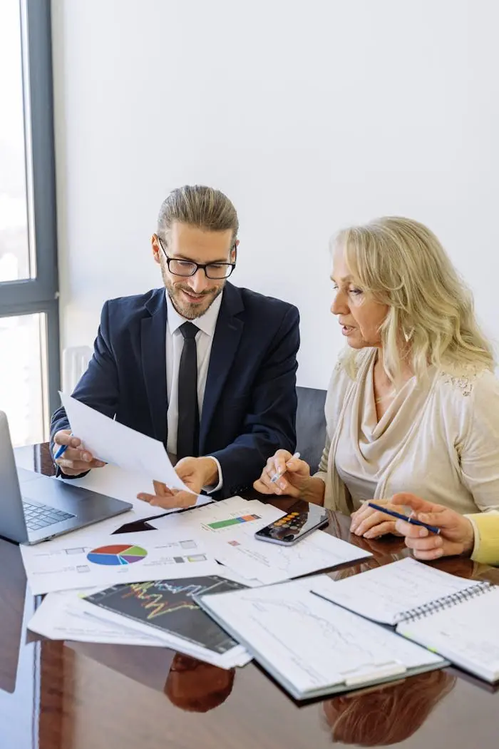 An advisor and a client reviewing documents and charts together