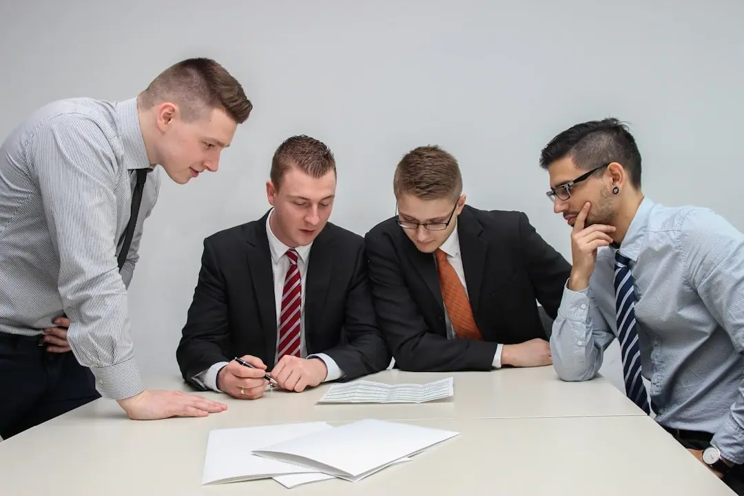 Four colleagues reviewing a document together at a table